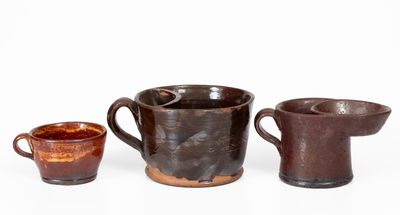 Lot of Three: Two Redware Shaving Mugs and Yellow Slip Decorated Redware Cup