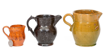 Three Glazed American Redware Pitchers, 19th century