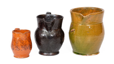 Three Glazed American Redware Pitchers, 19th century