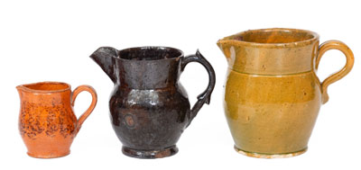 Three Glazed American Redware Pitchers, 19th century