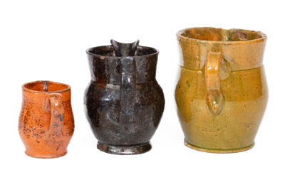 Three Glazed American Redware Pitchers, 19th century