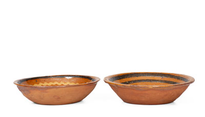 Two Small Slip-Decorated Redware Bowls, Mid-Atlantic or Southern origin, early to mid 19th century