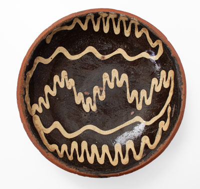 Slip-Decorated Redware Charger, English origin, 18th century