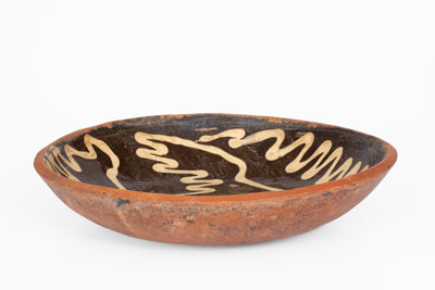 Slip-Decorated Redware Charger, English origin, 18th century