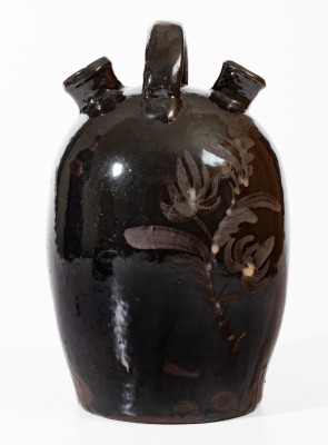 Extremely Rare Albany-Slip-Glazed Stoneware Harvest Jug with White-Slip Floral Decoration, attributed to the Hyssong Family, Cassville, PA, fourth quarter 19th century.