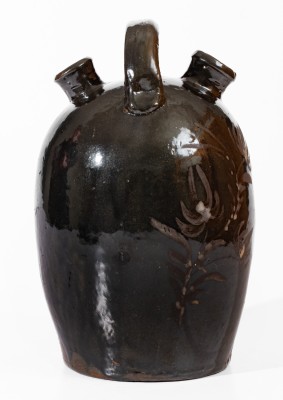 Extremely Rare Albany-Slip-Glazed Stoneware Harvest Jug with White-Slip Floral Decoration, attributed to the Hyssong Family, Cassville, PA, fourth quarter 19th century.